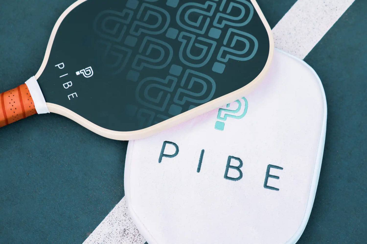 Two pickleball paddles with 'PIBE' branding on a green and white background