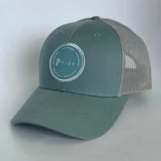 Green trucker cap with a PIBE logo on a white background