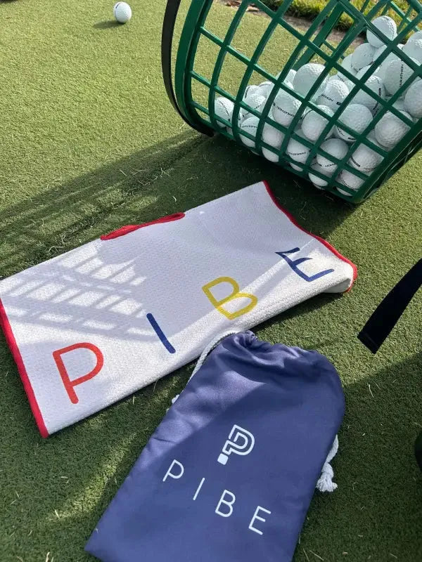 Country club style for men featuring golf towel and laid-back summer vibes