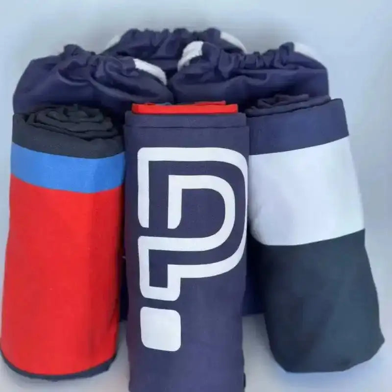 Set of rolled-up towels in various colors with a logo on a white background